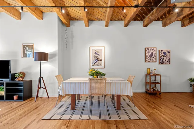 a view of a room with wooden floor and furniture