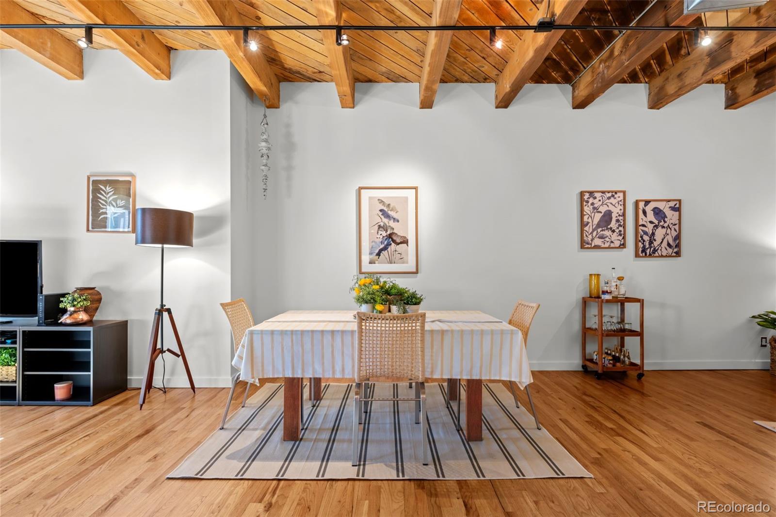 1745 Wazee Street, Unit 3C Denver, CO 80202 - Photo 7 of 23 a view of a room with wooden floor and furniture