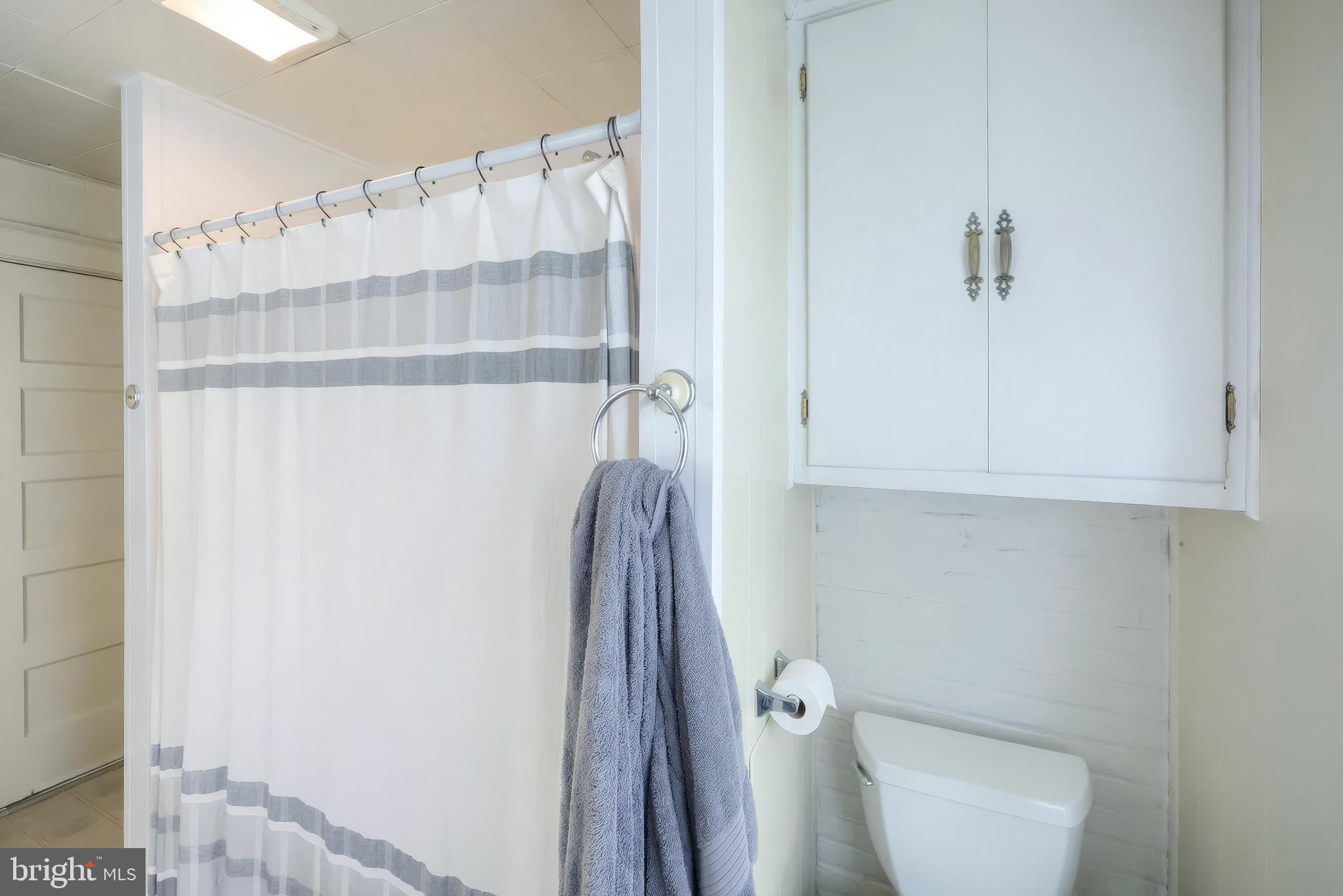 6016 Baltimore Pike Littlestown, PA 17340 - Photo 13 of 32 a bathroom with a shower a toilet and sink