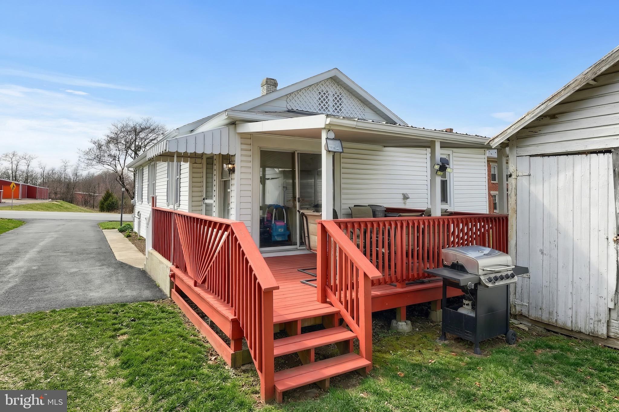 6016 Baltimore Pike Littlestown, PA 17340 - Photo 20 of 32 a view of a house with a yard and deck