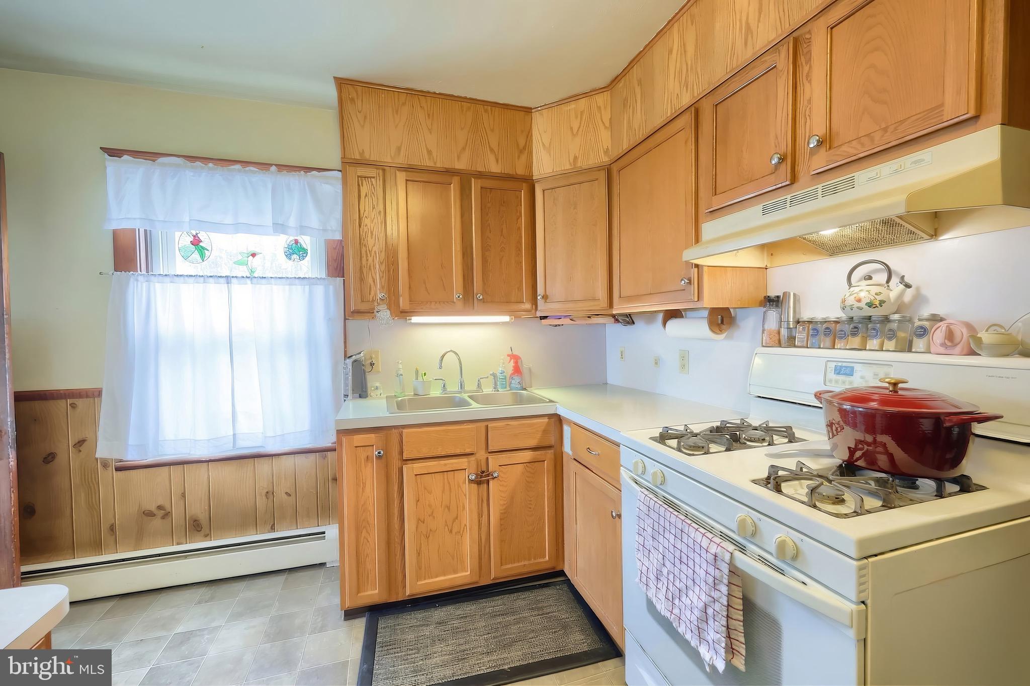 6016 Baltimore Pike Littlestown, PA 17340 - Photo 7 of 32 a kitchen with stainless steel appliances granite countertop a sink stove and refrigerator