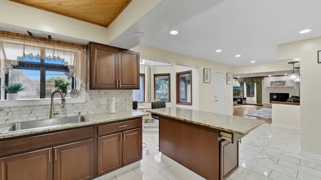 a kitchen with stainless steel appliances granite countertop a sink and a counter top space