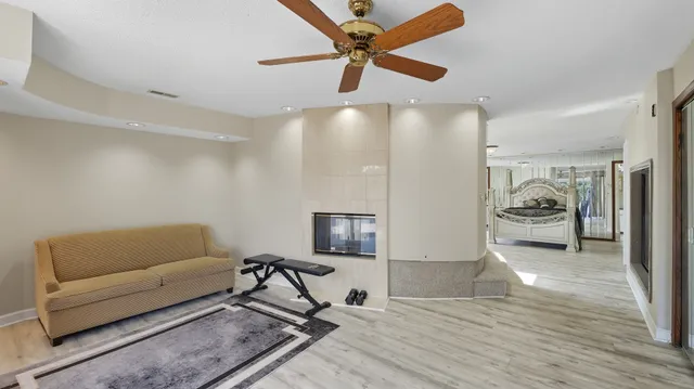 a living room with furniture and a ceiling fan