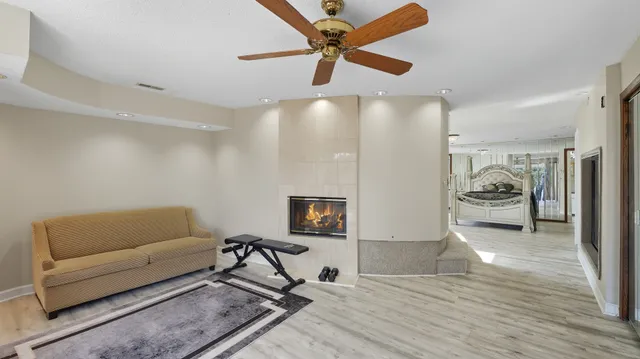 a living room with furniture and a ceiling fan