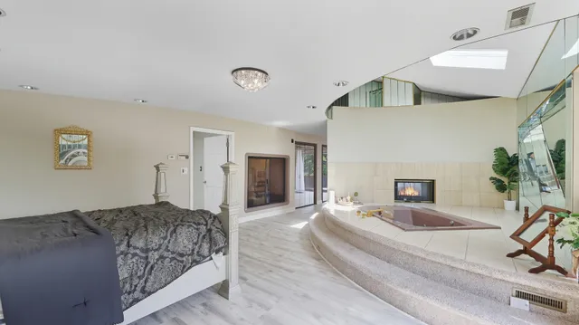 a spacious bedroom with a bed and a couch