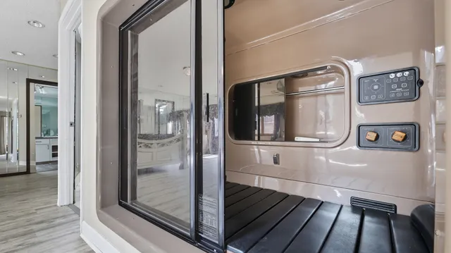 a view of a hallway with wooden floor