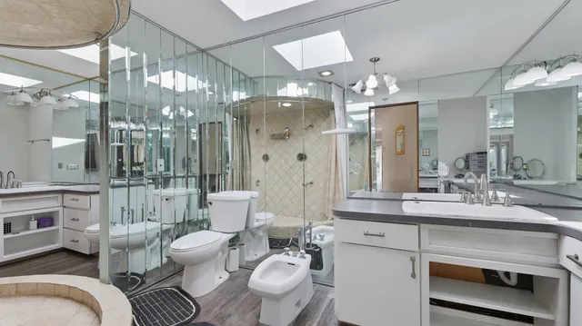 a bathroom with a double vanity sink mirror and toilet