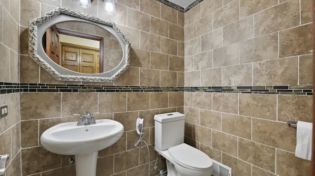 a bathroom with a sink toilet and a mirror
