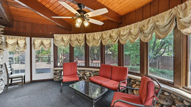 a view of a backyard with wooden fence and plants