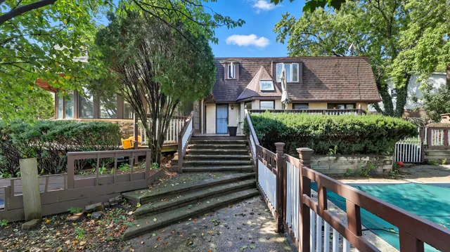 a view of balcony with wooden floor and fence
