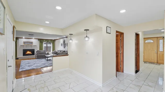 a view of a livingroom with kitchen and fireplace