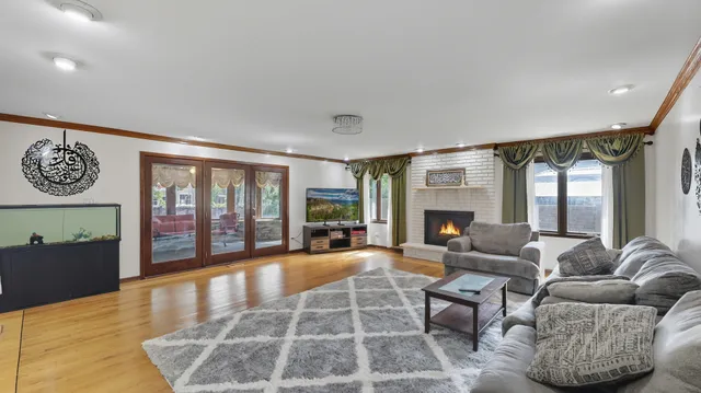 a living room with furniture large window and a fireplace