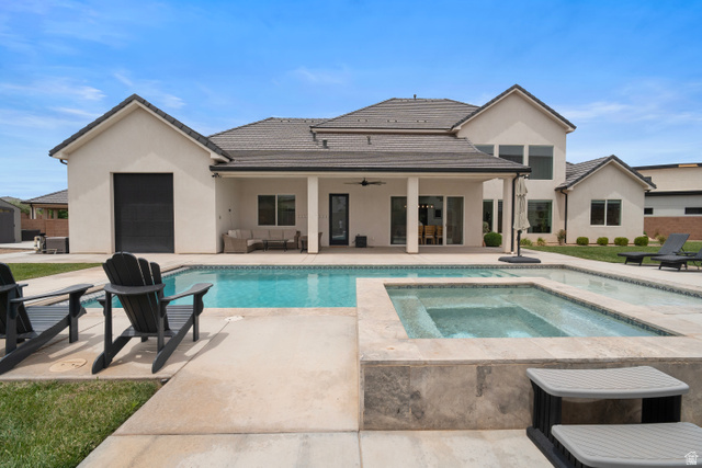 2278 Tawny Ridge Circle St. George, UT 84790 - Photo 51 of 61 Expansive backyard featuring a rectangular swimming pool, an integrated spa with stone surround, a covered patio with recessed lighting, and a stucco exterior.
