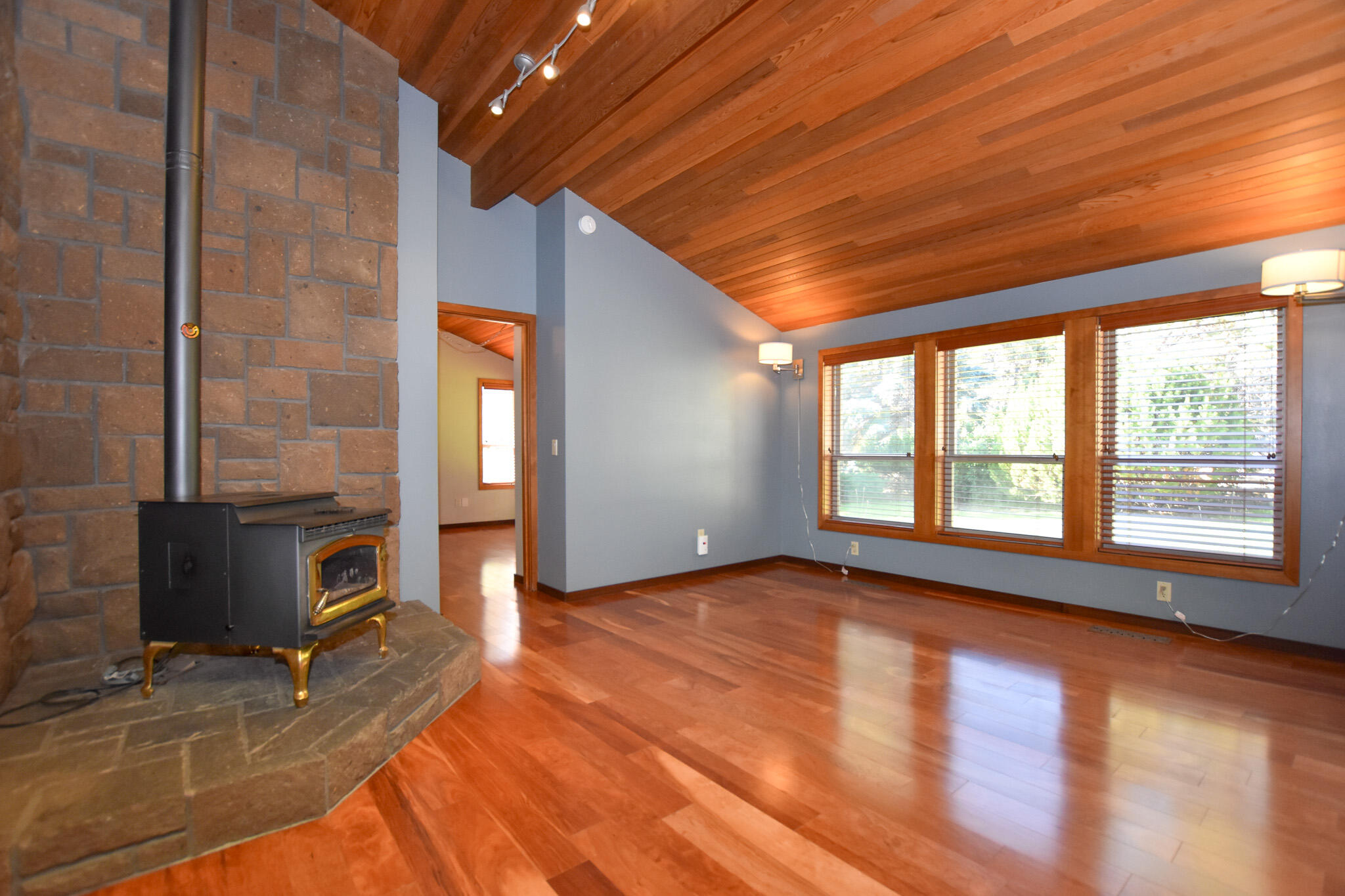 64730 Sylvan Loop Bend, OR 97701 - Photo 6 of 46 a view of an empty room with window and wooden floor