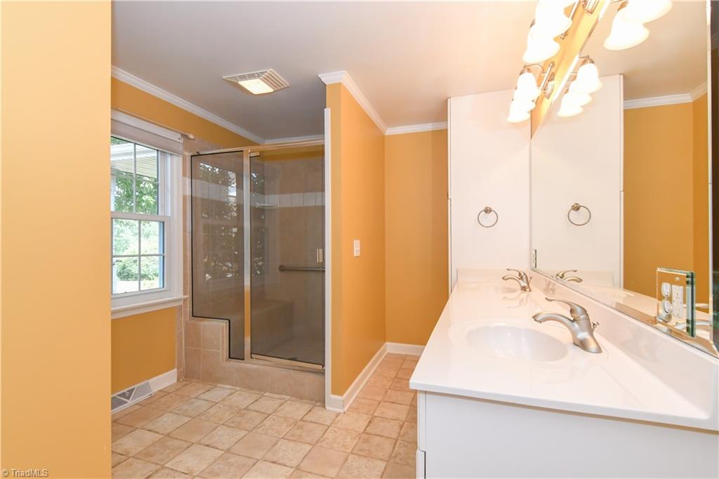 7836 Alcorn Road Oak Ridge, NC 27310 - Photo 14 of 28 Master Bath - updated in 2008 - double 36" vanity, walk-in shower with bench and grab bar.