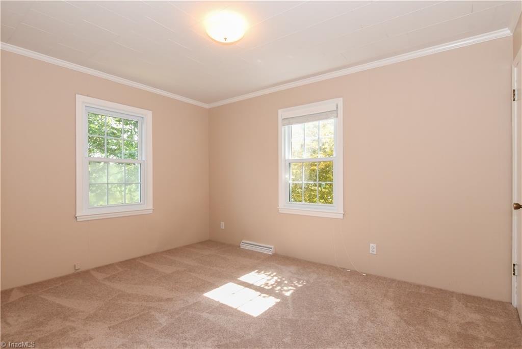 7836 Alcorn Road Oak Ridge, NC 27310 - Photo 17 of 28 This is the 3rd bedroom that is located on the front of the home. Another light filled room with new carpet.