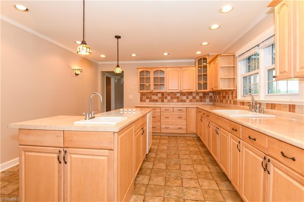 7836 Alcorn Road Oak Ridge, NC 27310 - Photo 4 of 28 An abundance of cabinet and drawer space. Notice the decorative tile back splash.