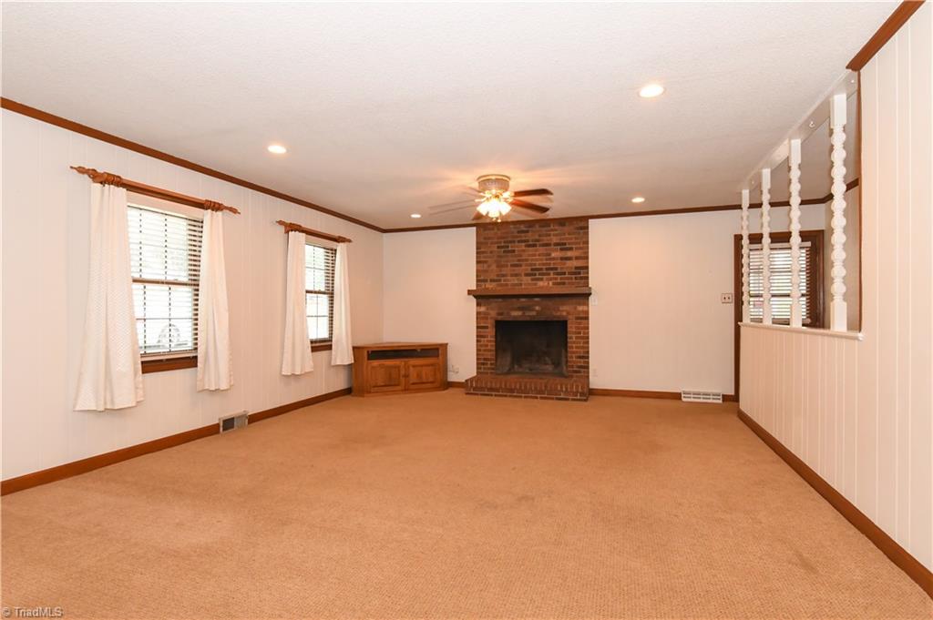7836 Alcorn Road Oak Ridge, NC 27310 - Photo 7 of 28 Family Room with Wood Burning Fireplace - great space for placing furniture, hanging out with family and friends.