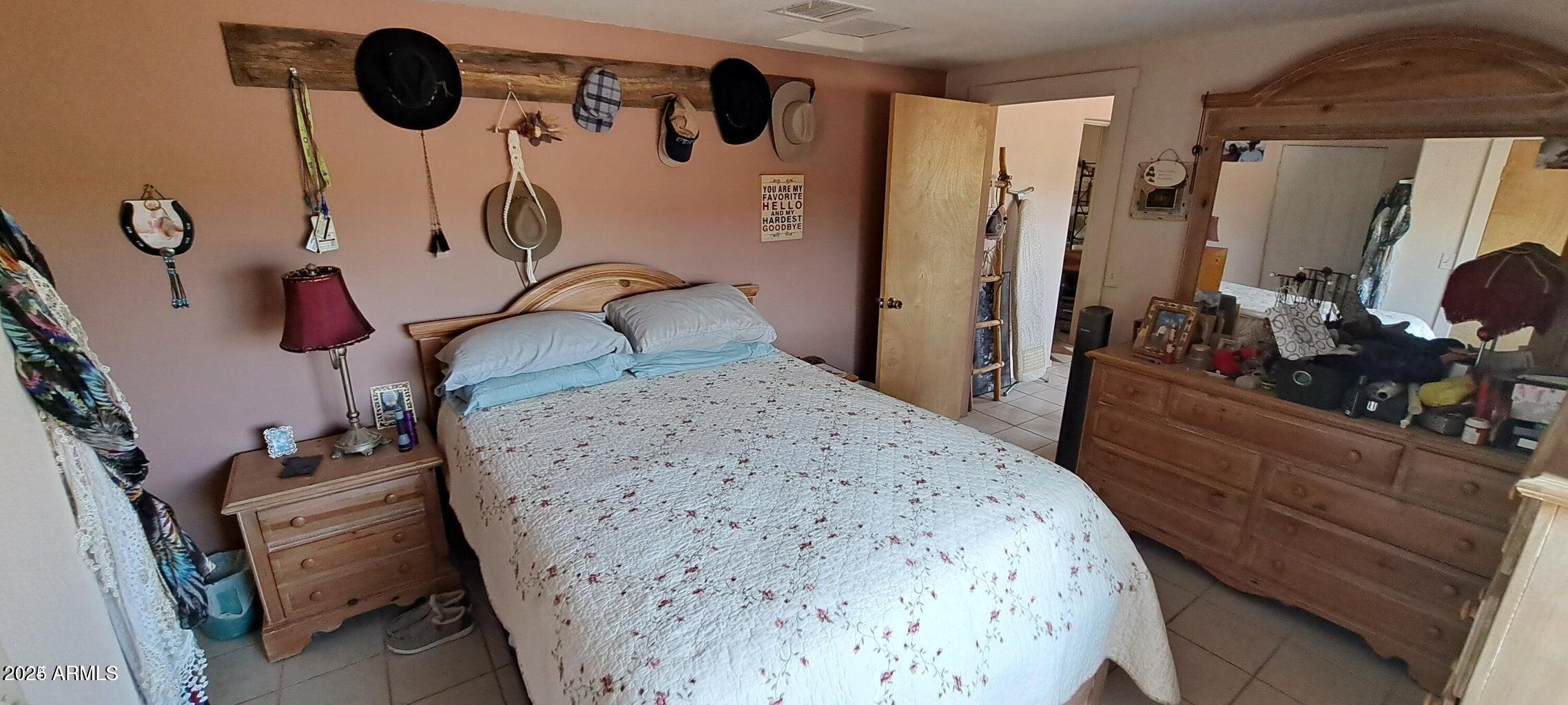 653 East Border Road Bisbee, AZ 85603 - Photo 18 of 29 a bedroom with a bed and a dresser