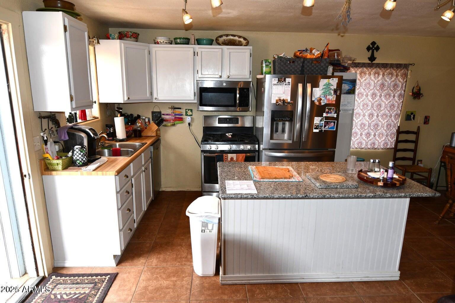 653 East Border Road Bisbee, AZ 85603 - Photo 10 of 29 a view of a living room with furniture and a flat screen tv