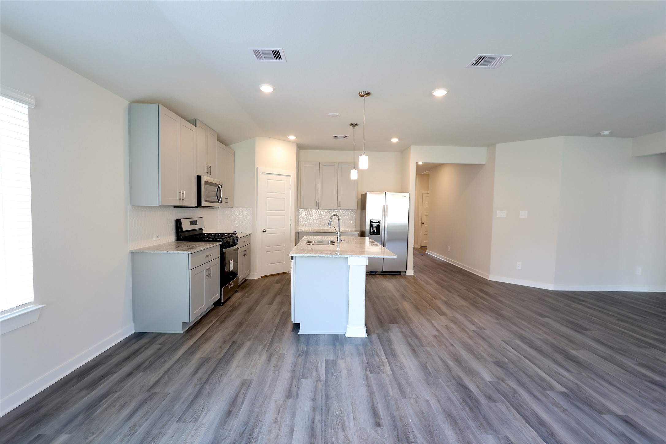 1435 Waggoner Rnch Trail Conroe, TX 77301 - Photo 11 of 17 a kitchen with a refrigerator and wooden floor