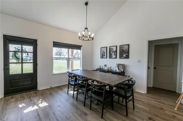 a living room with furniture a flat screen tv and kitchen view