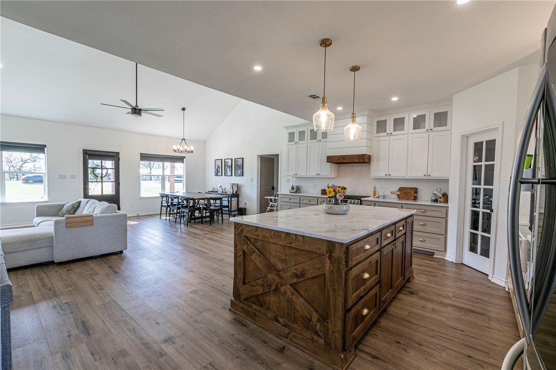 1973 Jackson Lane China Spring, TX 76633 - Photo 15 of 34 a large kitchen with stainless steel appliances granite countertop a lot of living room and wooden floors