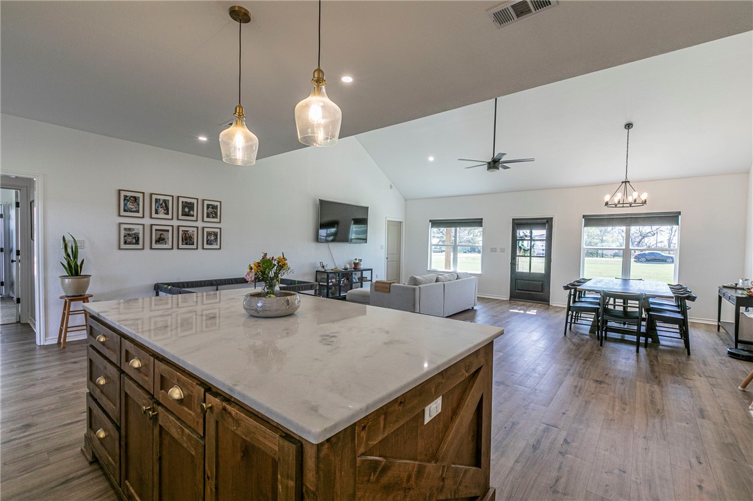 1973 Jackson Lane China Spring, TX 76633 - Photo 16 of 34 a view of kitchen island dining room wooden floor and living room