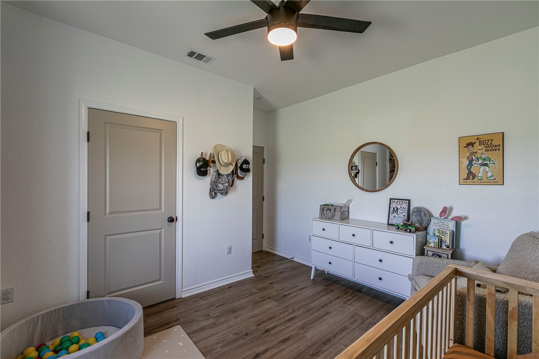 1973 Jackson Lane China Spring, TX 76633 - Photo 21 of 34 a view of a bedroom with wooden floor