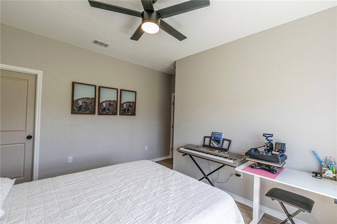 1973 Jackson Lane China Spring, TX 76633 - Photo 23 of 34 a bedroom with a bed and a chandelier