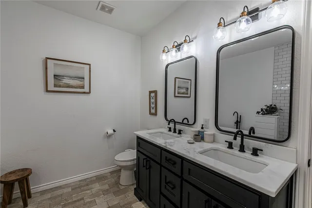 a bathroom with a sink toilet and mirror