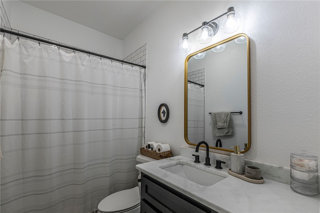 1973 Jackson Lane China Spring, TX 76633 - Photo 28 of 34 a bathroom with a sink toilet and mirror