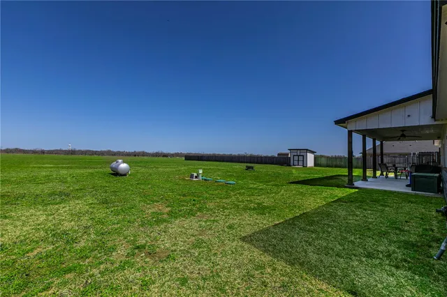 a view of a green field with clear sky
