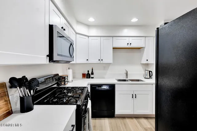 a kitchen with a sink a stove and refrigerator