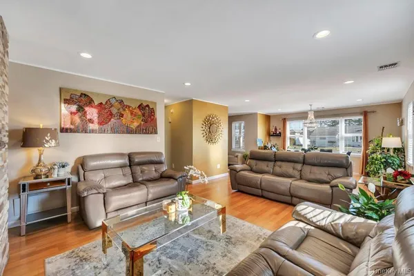 a living room with furniture a couch and a painting on the wall