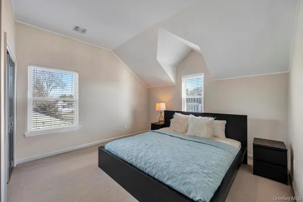 a bedroom with a bed and window