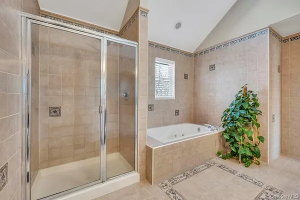 a bathroom with a tub shower and trees