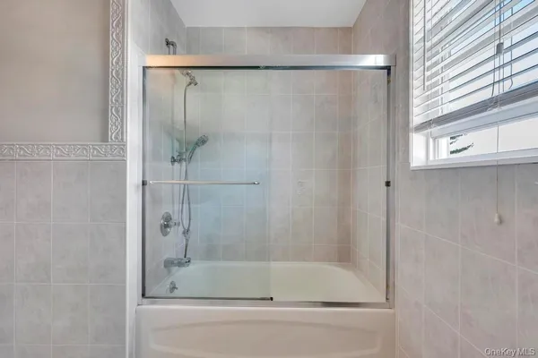 a bathroom with a bathtub and a shower
