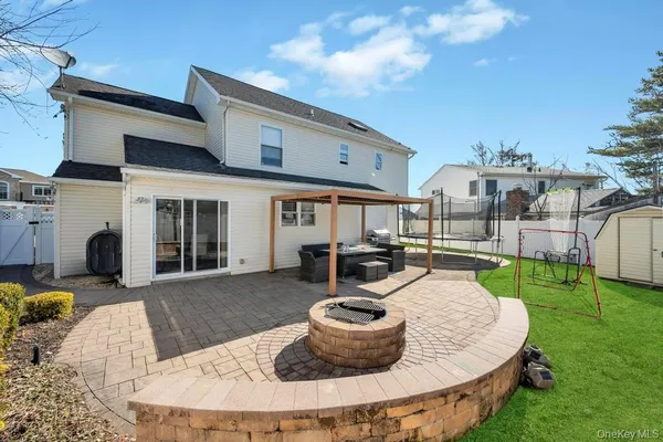 a view of a house with backyard sitting area and swimming pool