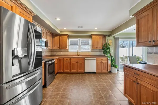a kitchen with stainless steel appliances a stove a sink and a refrigerator