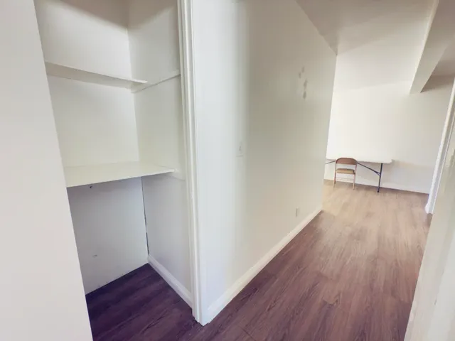 a view of hallway with wooden floor