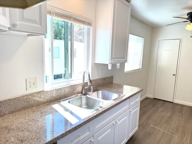 a kitchen with granite countertop a sink and a window