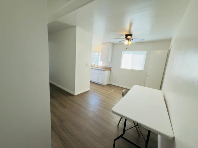 a view of a workspace with furniture and wooden floor