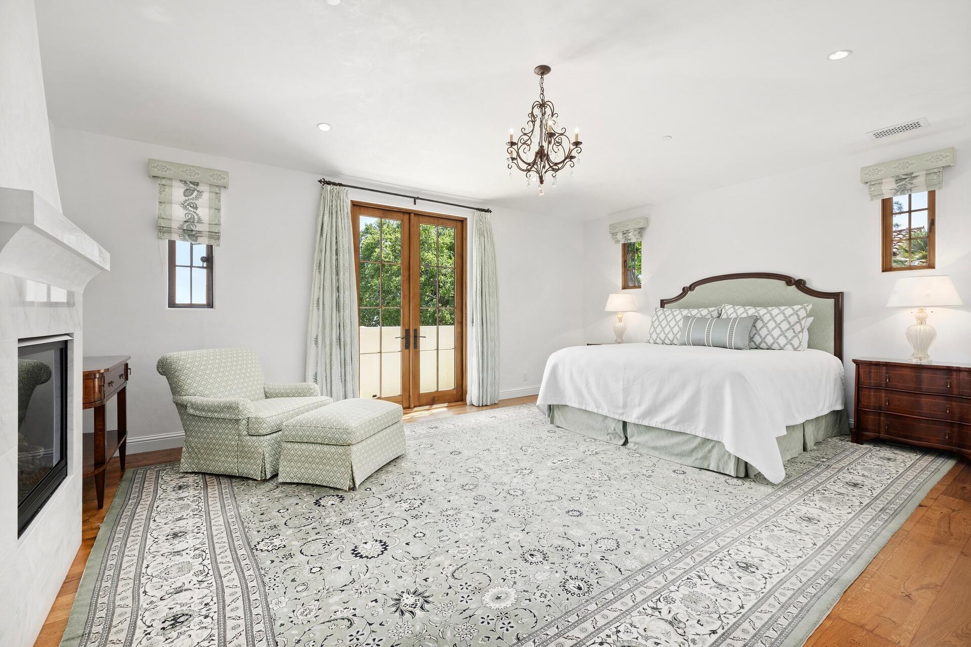 1117 Las Alturas Road Santa Barbara, CA 93103 - Photo 11 of 28 a bedroom with a large bed and a chandelier