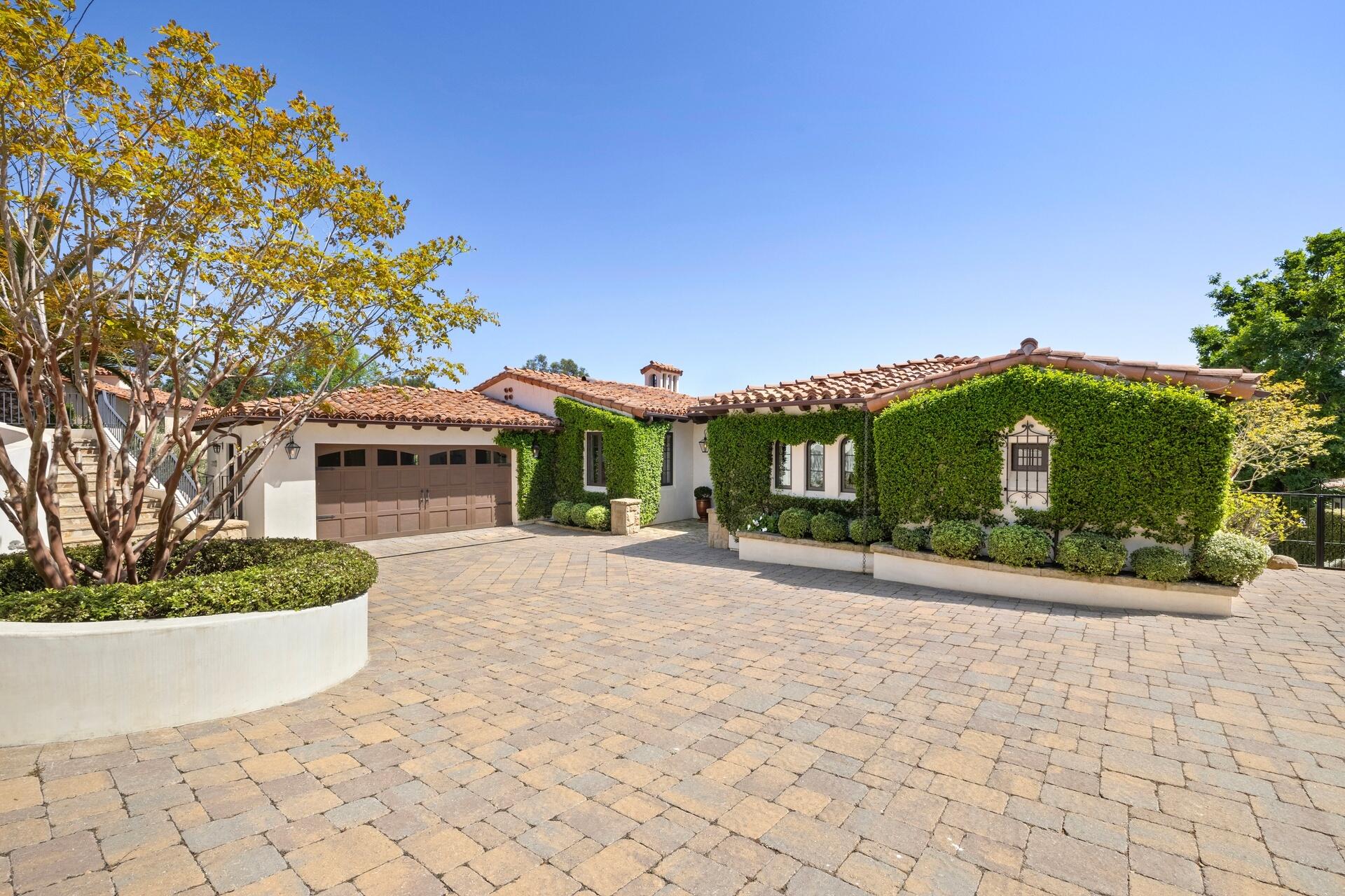 1117 Las Alturas Road Santa Barbara, CA 93103 - Photo 3 of 28 a front view of a house with a yard and a garden