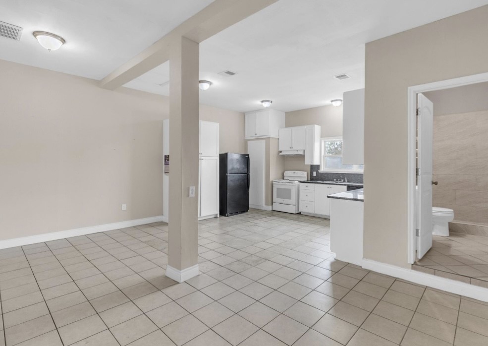 9678 Interstate 10 Frontage Road, Unit 1 Sealy, TX 77474 - Photo 12 of 19 a view of a kitchen with refrigerator and chairs