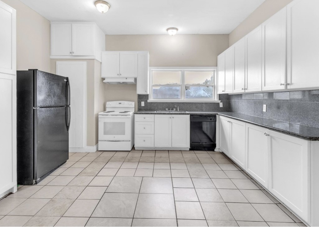 9678 Interstate 10 Frontage Road, Unit 1 Sealy, TX 77474 - Photo 14 of 19 a kitchen with a refrigerator sink and cabinets