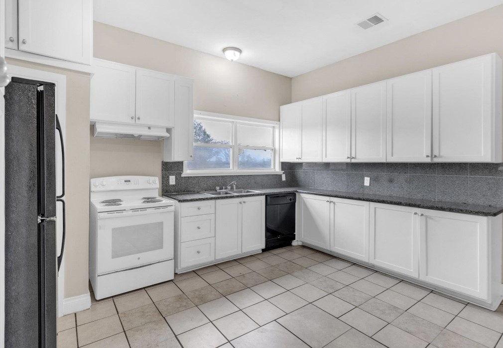 9678 Interstate 10 Frontage Road, Unit 1 Sealy, TX 77474 - Photo 15 of 19 a kitchen with granite countertop white cabinets and white appliances