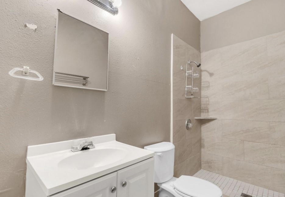 9678 Interstate 10 Frontage Road, Unit 1 Sealy, TX 77474 - Photo 16 of 19 a bathroom with a sink toilet and shower