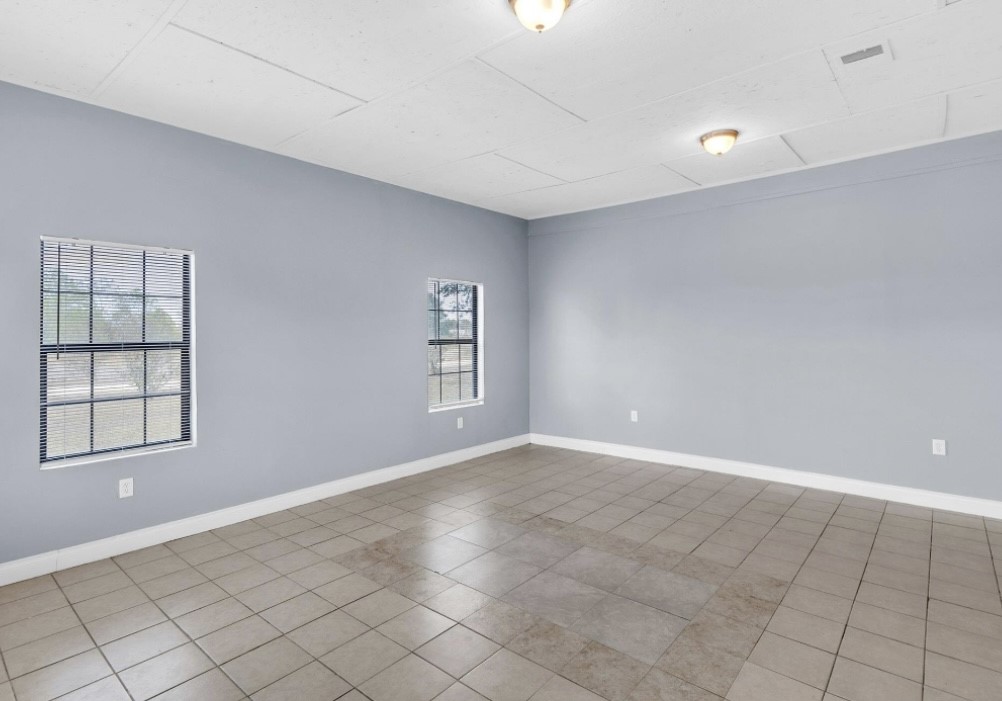 9678 Interstate 10 Frontage Road, Unit 1 Sealy, TX 77474 - Photo 18 of 19 a view of an empty room with window and chandelier fan